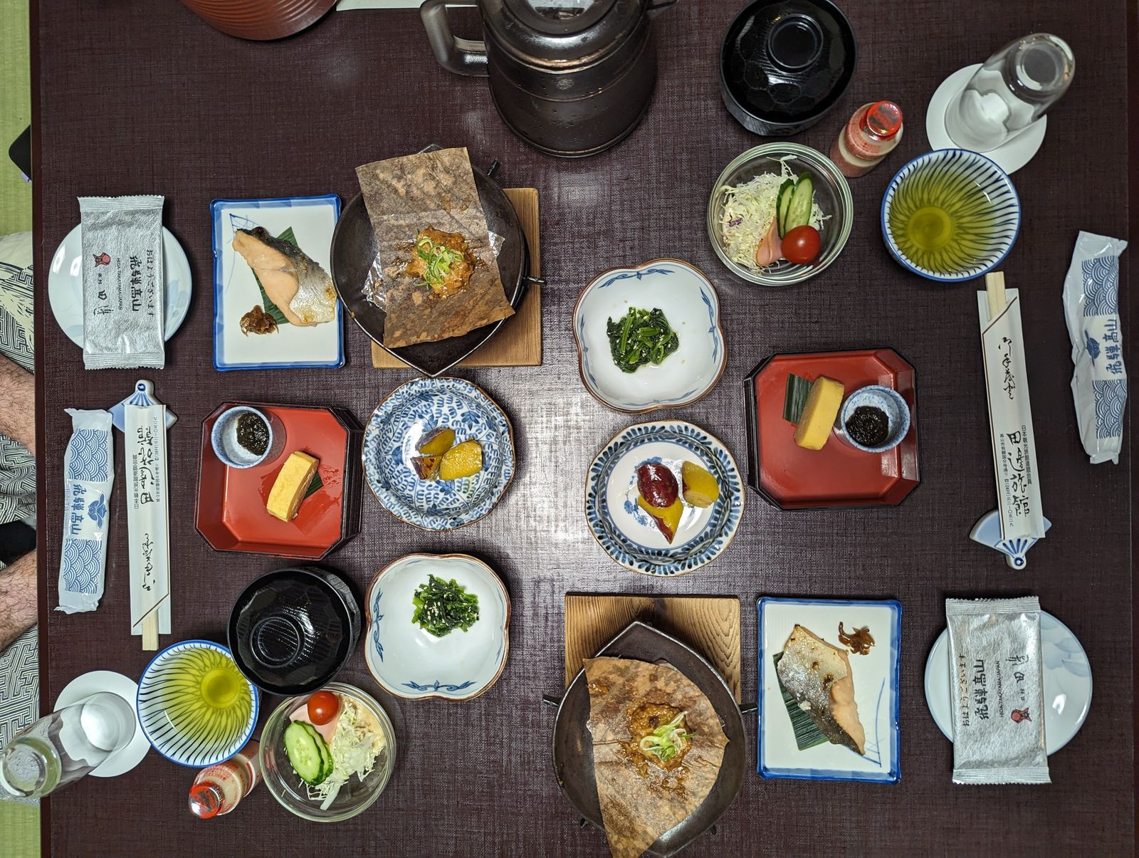 A photo of many different dishes of food on a table. There are all sorts of local food.